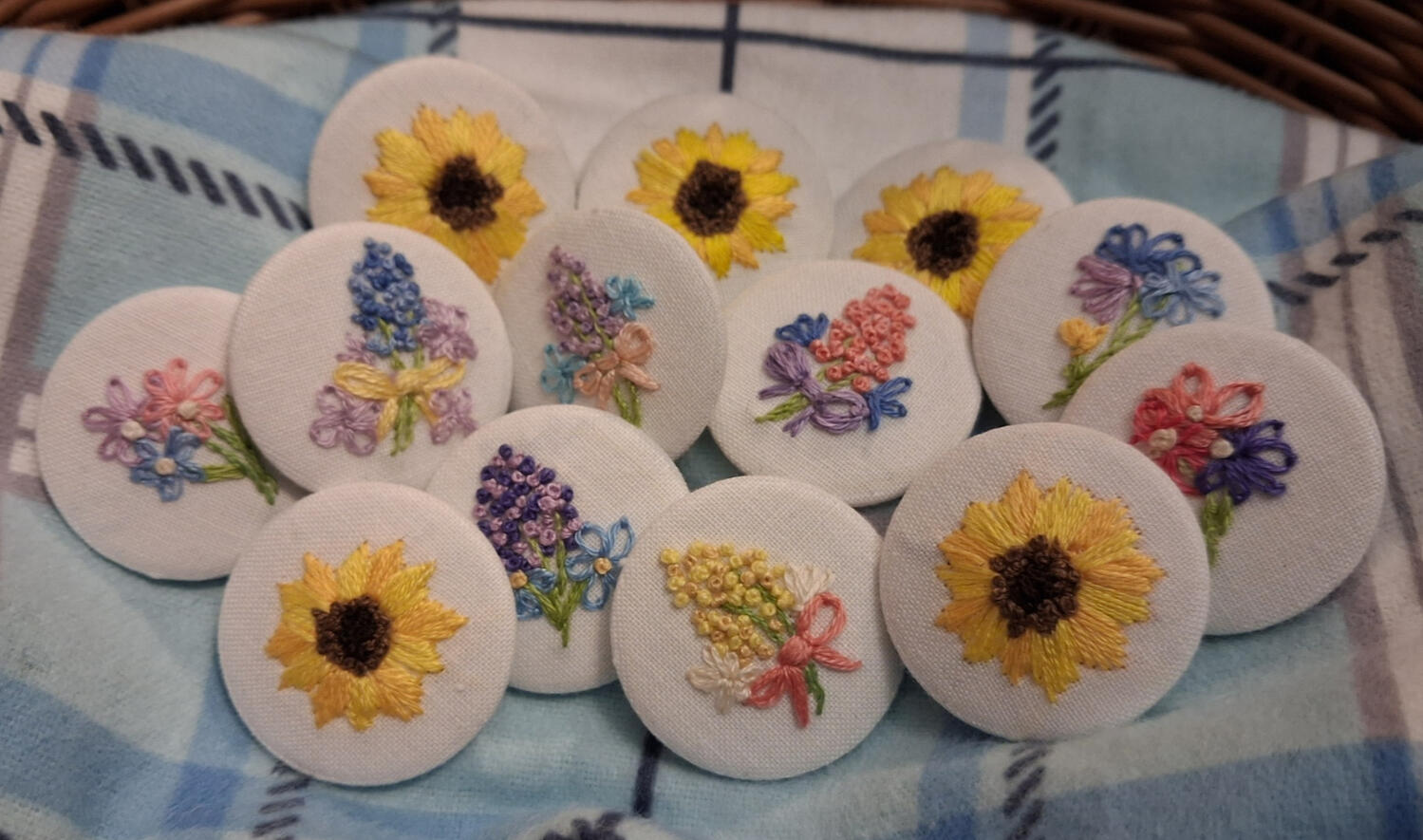 Photograph of hand embroidered button badges.
